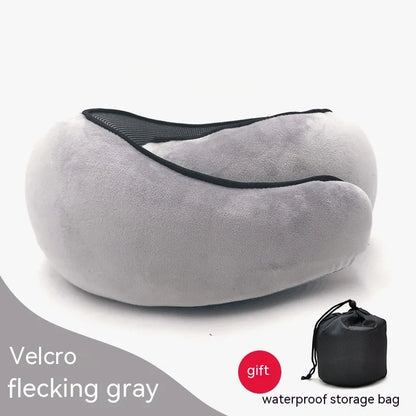 Gray travel pillow with a black storage bag on a white background