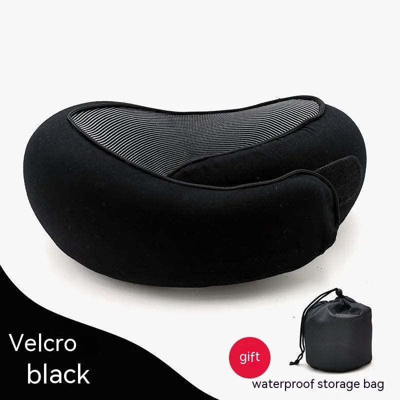 Black travel pillow with a small black storage bag on a white background