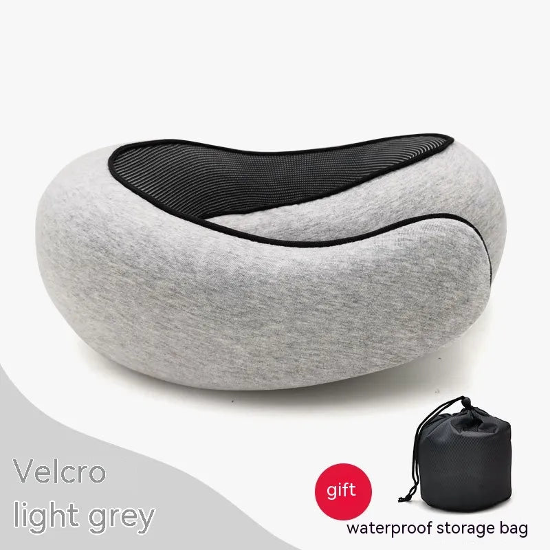 Gray neck pillow with black interior on a white background, accompanied by a waterproof storage bag.